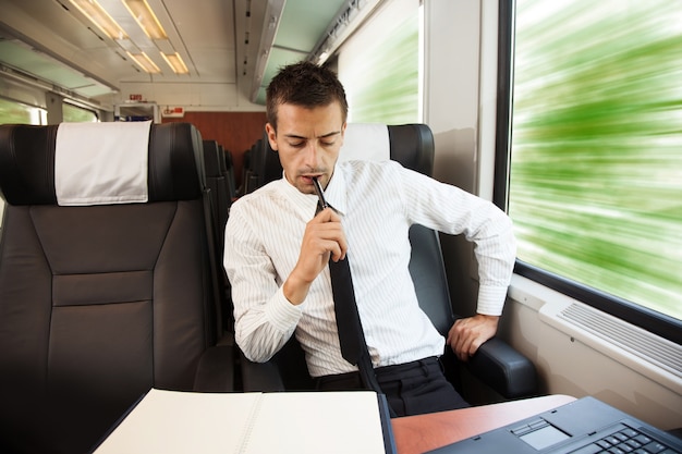 Jovem empresário trabalhando no trem de velocidade