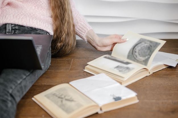 Jovem estudando com livros e laptop