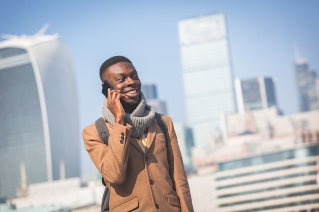 Jovem falando no celular com a cidade de Londres