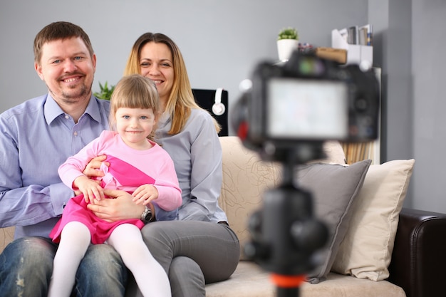 Foto jovem família feliz sentar no sofá fazendo retrato de sessão de foto
