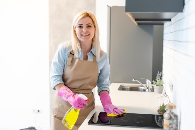 Jovem fazendo trabalhos domésticos, limpando a cozinha