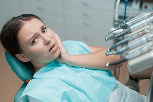 jovem fazendo tratamento odontológico no consultório do dentista