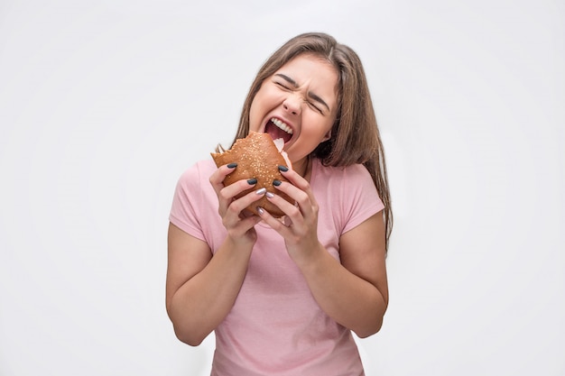 Jovem feliz detém hambúrguer