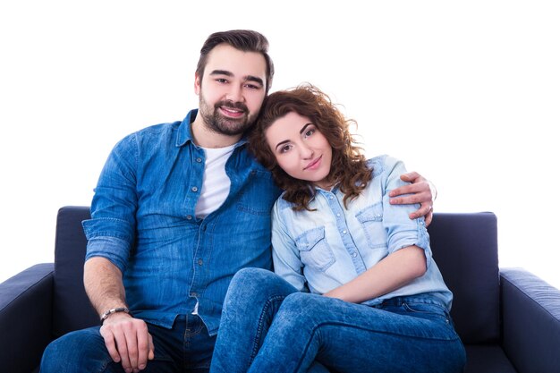 Jovem feliz e mulher sentada no sofá isolado no fundo branco