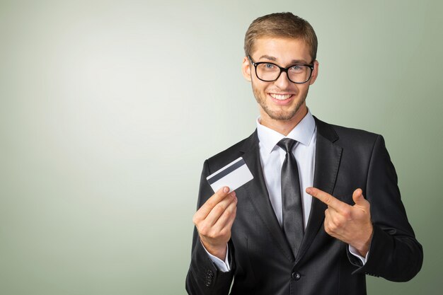 Jovem feliz segurando o cartão de crédito