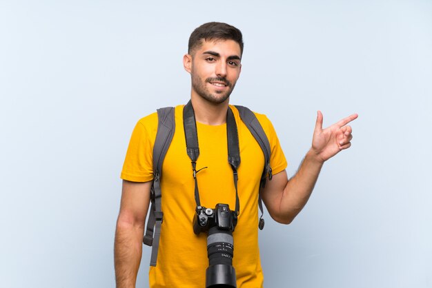 Jovem fotógrafo homem apontando o dedo para o lado