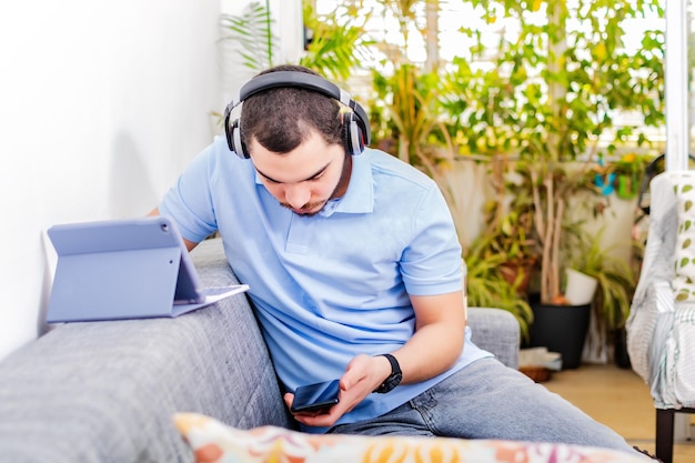 Jovem freelancer trabalhando em casa em um tablet Trabalho remoto