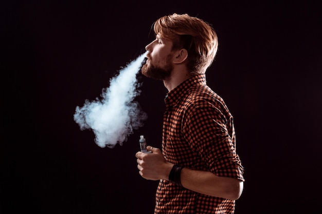 Foto jovem fumando cigarro eletrônico