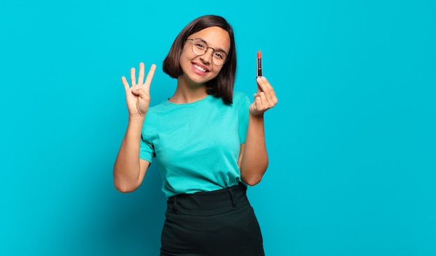 Jovem hispânica sorrindo e parecendo amigável, mostrando o número quatro ou o quarto com a mão para a frente, em contagem regressiva