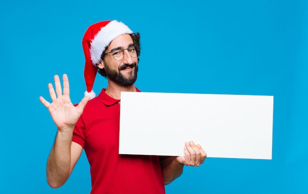 Jovem homem barbudo louco com chapéu de Papai Noel. Conceito de natal