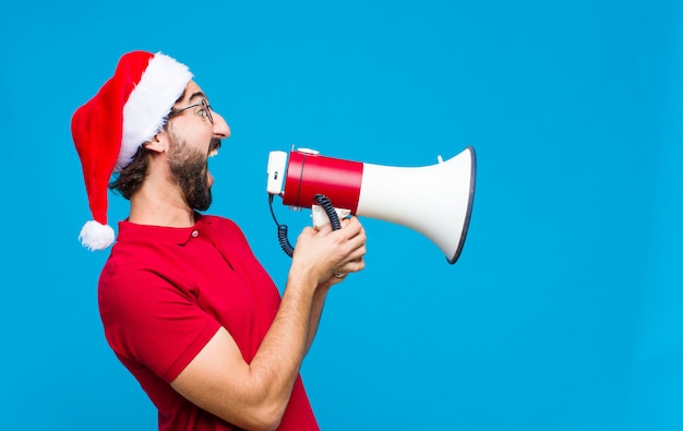 Jovem homem barbudo louco com chapéu de Papai Noel. Conceito de natal