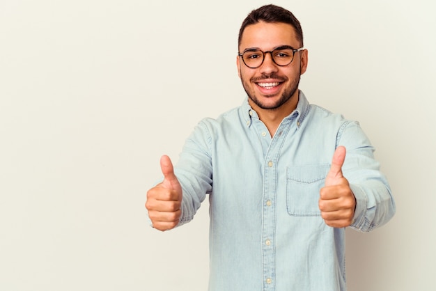 Jovem homem caucasiano isolado no branco sorrindo e levantando o polegar