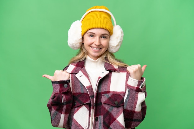 Jovem inglesa vestindo regalos de inverno sobre fundo isolado com polegares para cima gesto e sorrindo