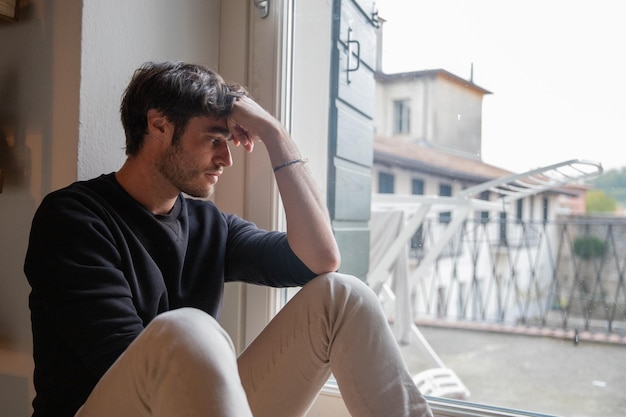 Jovem isolado solitário sentado no chão meditando o conceito de depressão