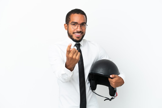 Jovem latim de negócios com capacete de motociclista isolado no fundo branco fazendo gesto de vinda