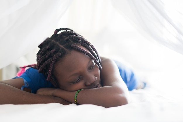 Jovem linda negra acordando na cama do quarto