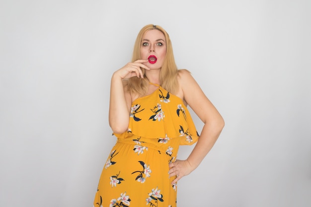 Jovem loira com vestido floral amarelo primavera verão