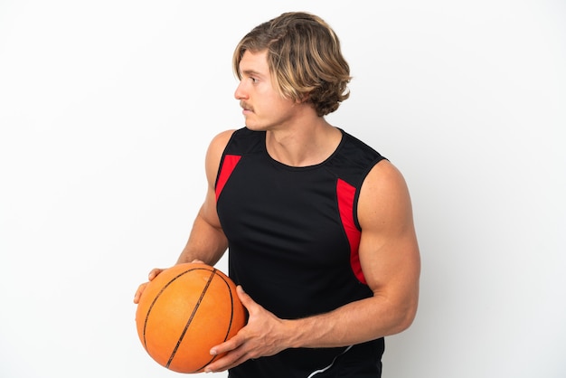 Jovem loiro isolado jogando basquete