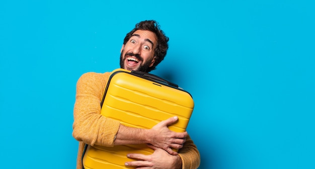 Jovem louco de barba com uma maleta