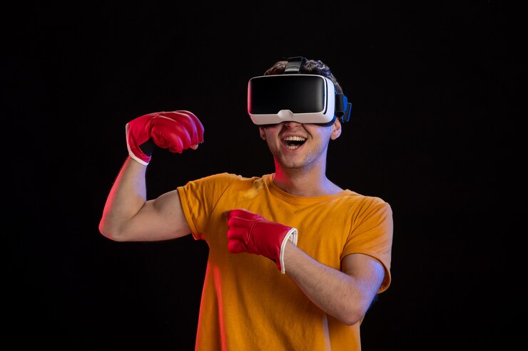 Foto jovem macho jogando realidade virtual com luvas de mamãe na superfície escura