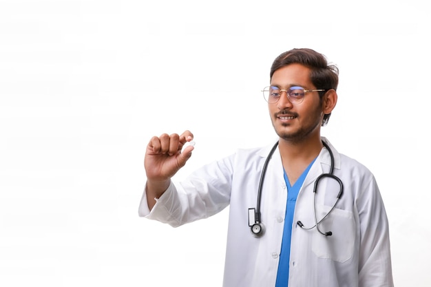 Jovem médico indiano segurando a pílula na mão.