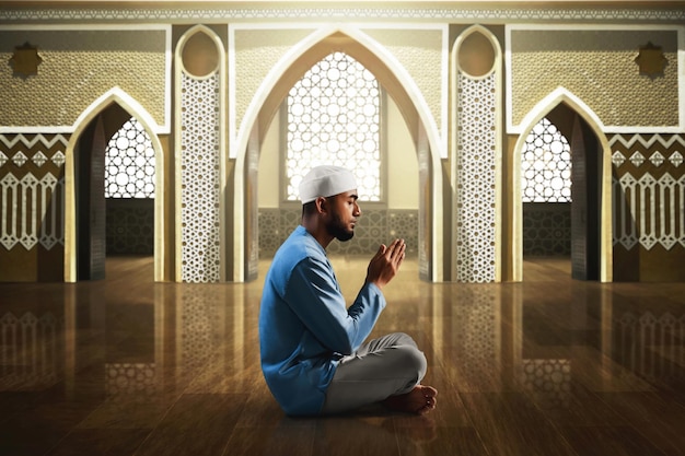 Jovem muçulmano asiático com barba orando na mesquita