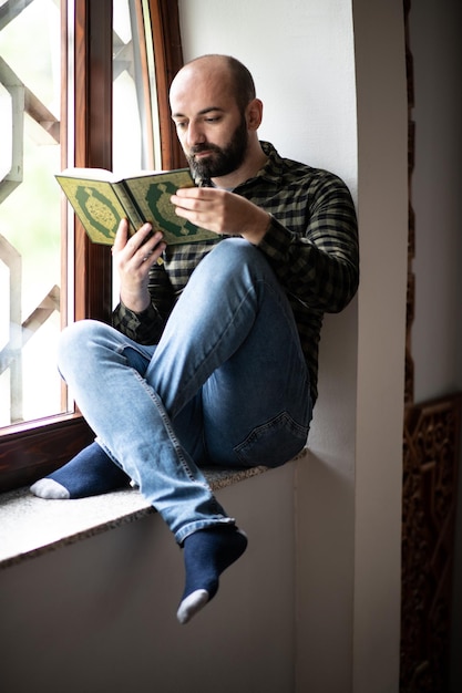 Jovem muçulmano lendo o Alcorão