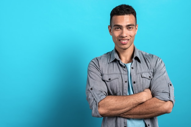 Foto jovem mulato feliz dobrou as mãos e em pé