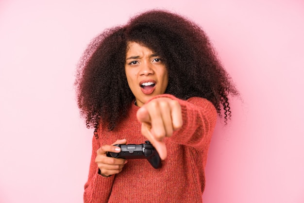 Jovem mulher afro segurando um comando de jogo isolado