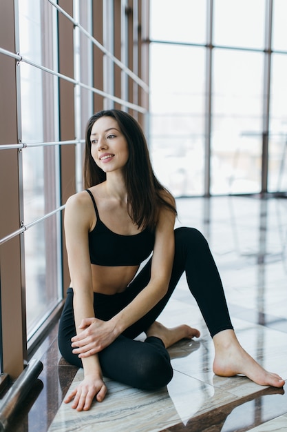 Jovem, mulher apta relaxando no chão