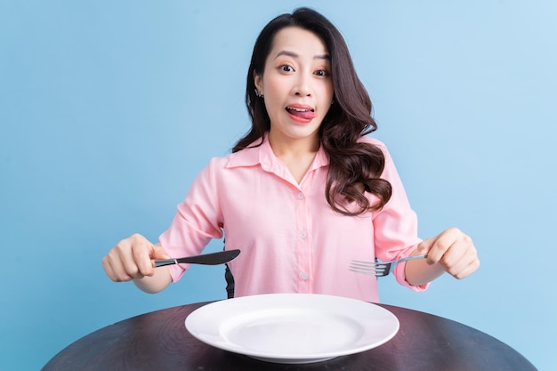 Jovem mulher asiática comendo o conceito de comer