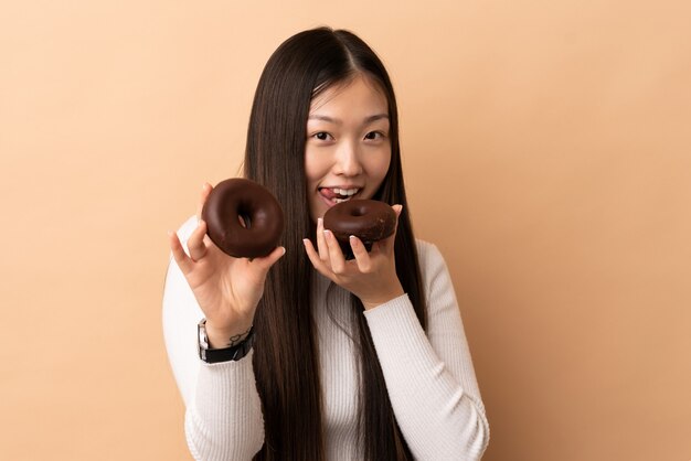 Jovem mulher asiática sobre parede isolada