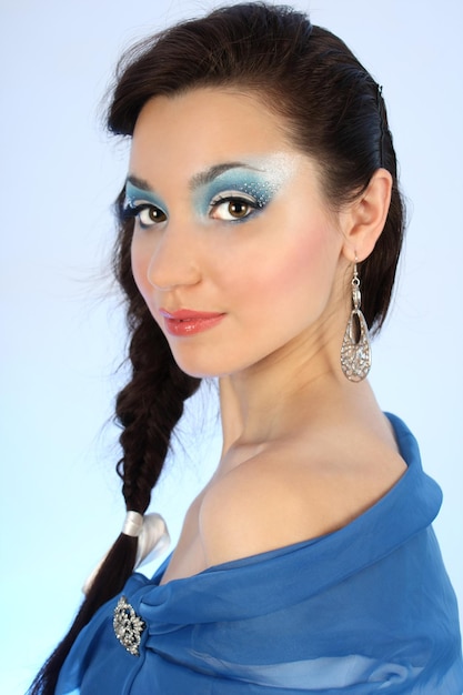 Jovem mulher atraente em azul com maquiagem