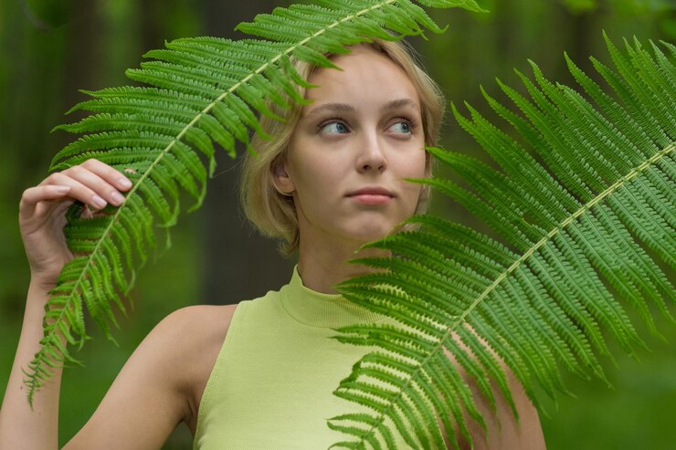 Foto jovem mulher bonita na floresta admirando a vegetação