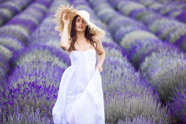 Jovem mulher bonita no campo de lavanda. Senhora em fundo de verão