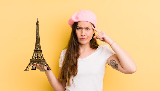 Jovem mulher bonita se sentindo confusa e confusa, mostrando que você é um conceito insano de paris