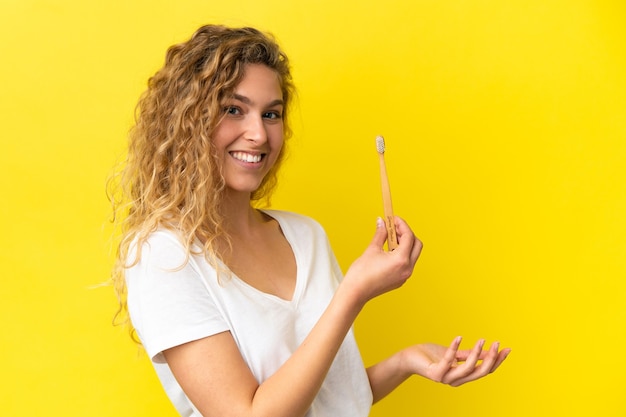 Jovem mulher caucasiana segurando uma escova de dentes