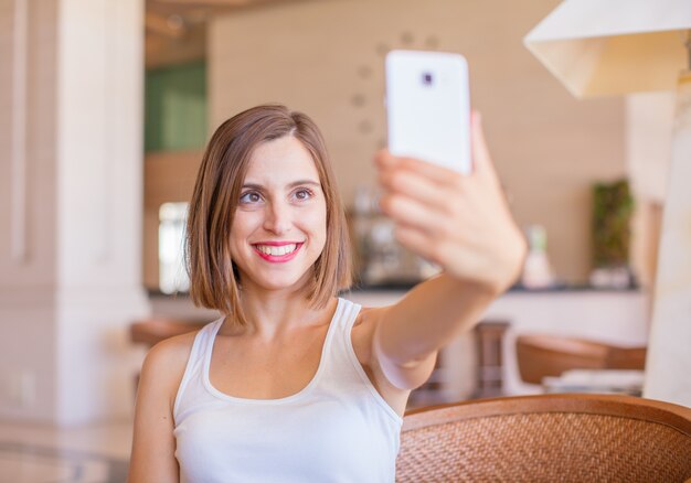 jovem mulher com telefone obile em um resort