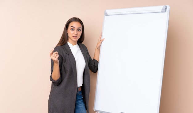 Jovem mulher dando uma apresentação no quadro branco, dando uma apresentação no quadro branco