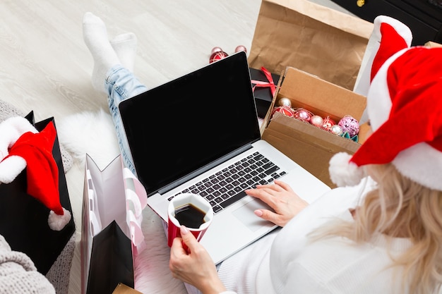 Jovem mulher encomendando presentes de Natal online