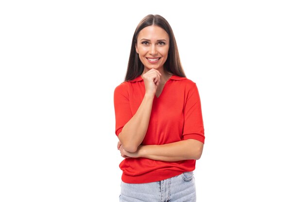 jovem mulher europeia encantadora com cabelos pretos está vestida com uma camiseta vermelha sobre um fundo branco