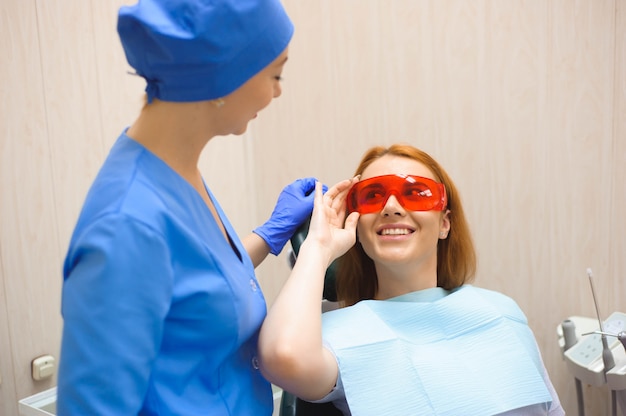 Jovem mulher fazendo check-up médico no consultório do dentista pelo médico