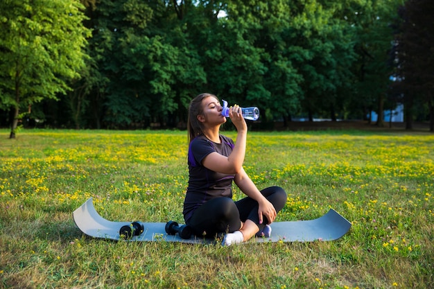 Jovem mulher fazendo exercícios no parque