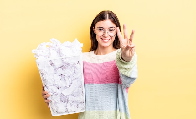 Jovem mulher hispânica sorrindo e parecendo amigável, mostrando o número três. conceito de lixo de falha