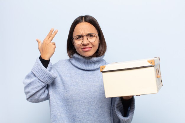 Jovem mulher latina se sentindo confusa e perplexa, mostrando que você está louco, louco ou fora de si