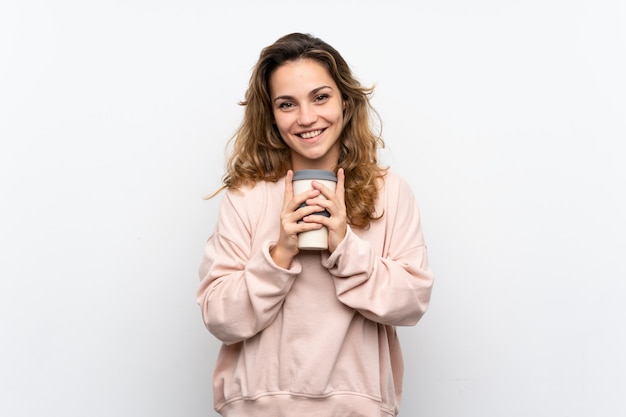 Jovem mulher loira segurando café para levar