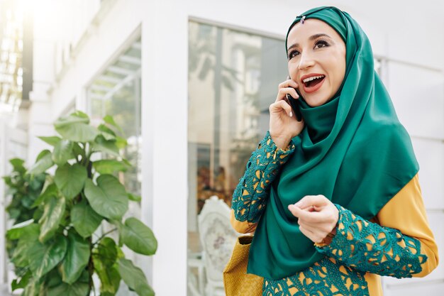 Jovem mulher muçulmana falando ao telefone