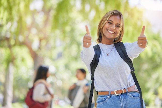 Jovem mulher polegares para cima e estudante universitário sim e sucesso no estudo acadêmico de educação e para aprender maquete acordo sorriso e bolsa de estudos com graduação e retrato no campus de nova york