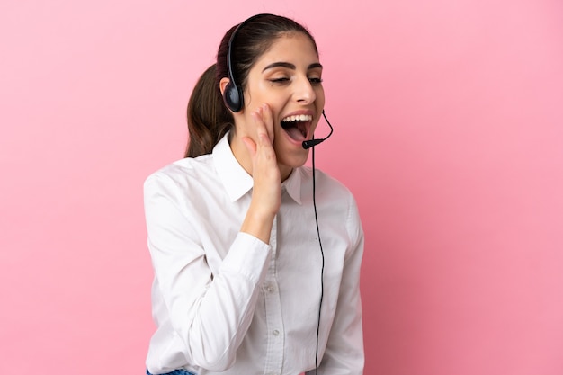 Jovem operador de telemarketing em um fundo isolado gritando com a boca bem aberta para o lado