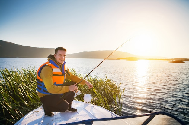 Jovem pescando em um barco